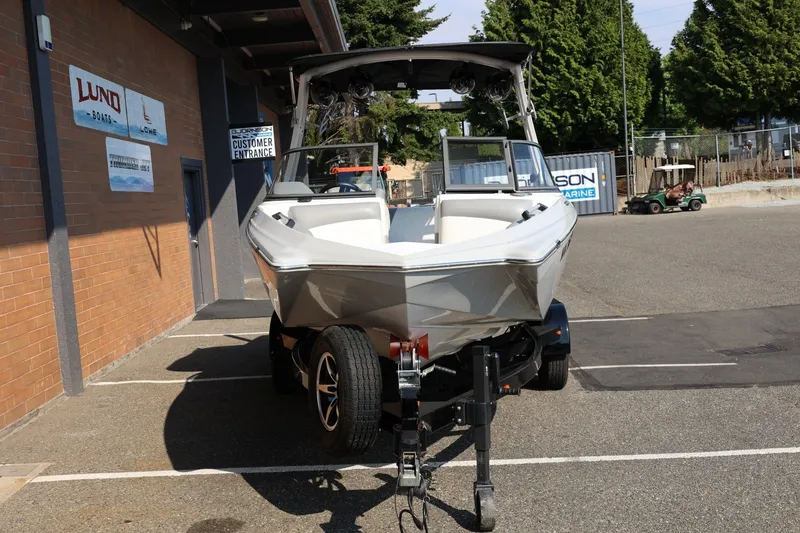 Slide: The Image of 2020 Tigé R20 boat on trailer outside a marine dealership. - 12