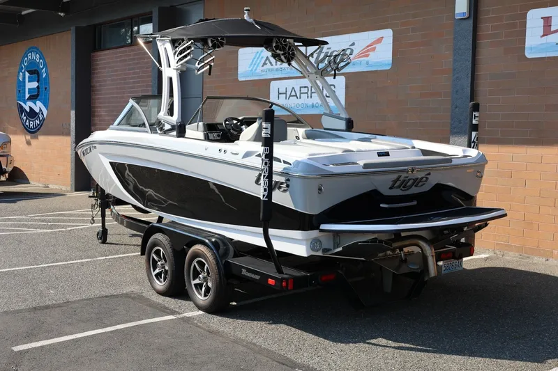 Slide: The Image of 2020 Tigé R20 boat on trailer, parked outside a marine dealership. - 3
