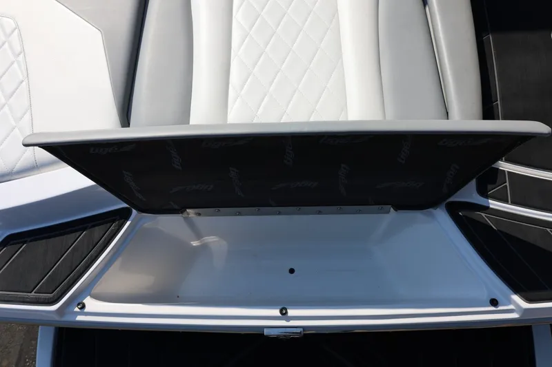 Slide: The Image of 2020 Tigé R20 boat interior with open storage compartment and quilted seating. - 20