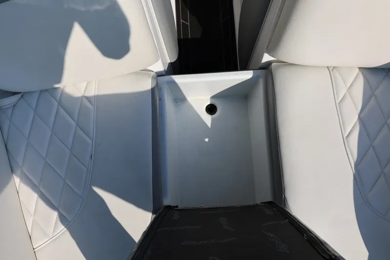 Slide: The Image of 2020 Tigé R20 boat interior with white quilted seats and storage compartment. - 47