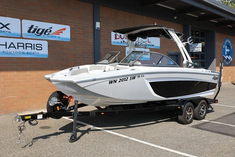 Slide: The Image of 2020 Tigé R20 boat on trailer outside dealership, showcasing sleek design and modern features. - 14