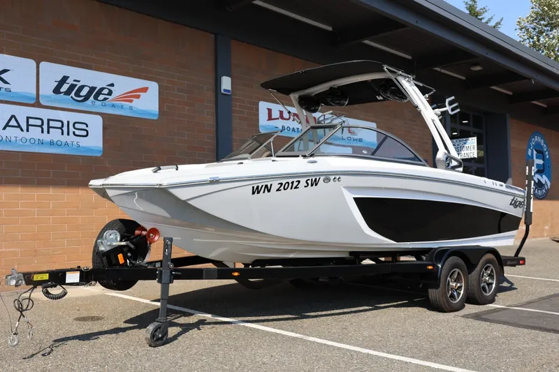 Slide: The Image of 2020 Tigé R20 boat on trailer outside dealership, showcasing sleek design and modern features. - 15