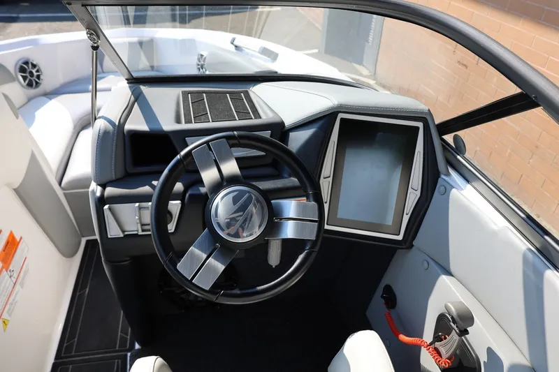 Slide: The Image of 2020 Tigé R20 boat dashboard with steering wheel and touchscreen display. - 35