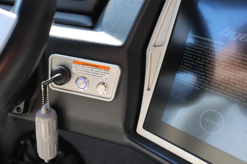 Slide: The Image of 2020 Tigé R20 boat dashboard with ignition key and touchscreen display. - 37