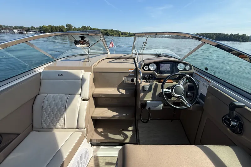 Slide: The Image of Interior view of 2018 Regal 28 Express boat with steering wheel and seating. - 21