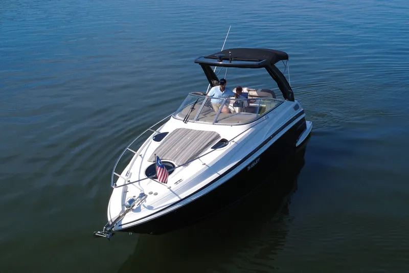 Slide: The Image of 2018 Regal 28 Express boat cruising on calm water with passengers onboard. - 13