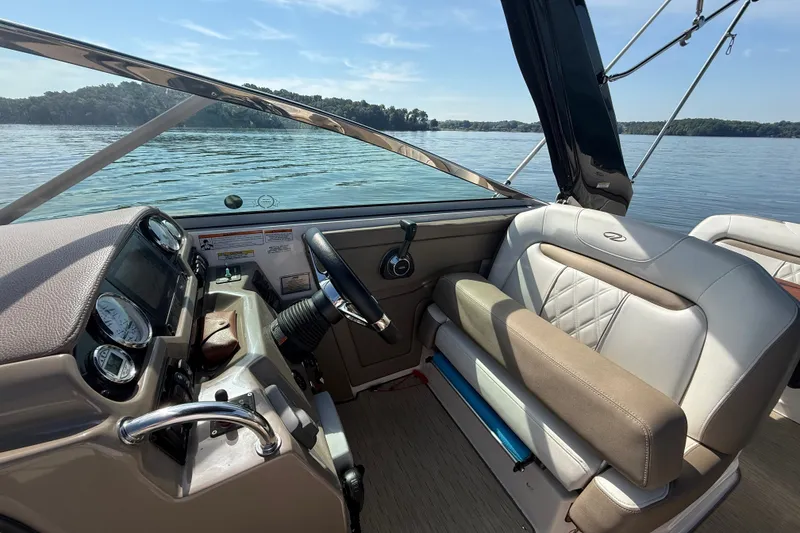 Slide: The Image of Interior view of 2018 Regal 28 Express boat cockpit with steering wheel and seating. - 19