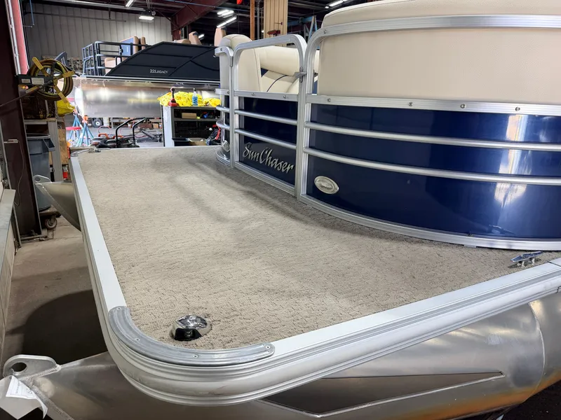 Slide: The Image of A 2015 SunChaser pontoon boat with a blue hull and beige interior upholstery. - 35