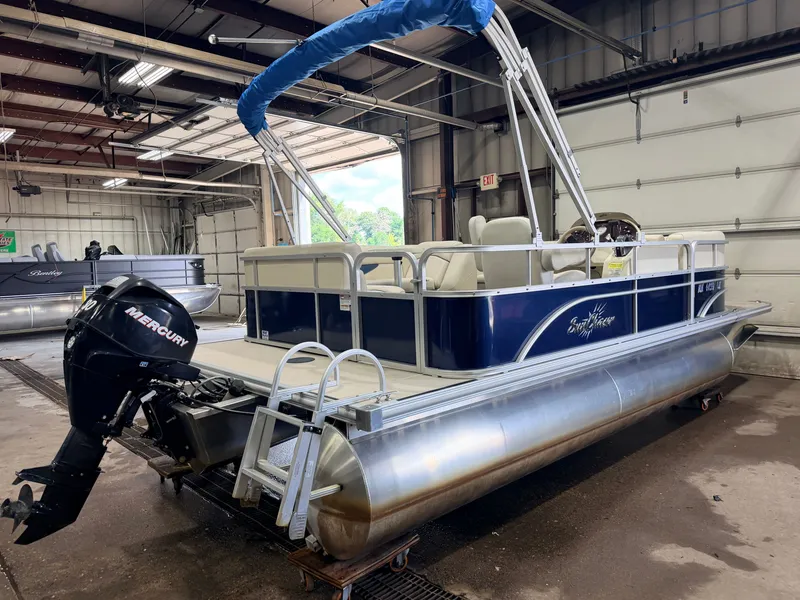 Slide: The Image of A 2015 SunChaser pontoon boat with a 30HP Mercury 4Stroke EFI engine in a warehouse. - 46