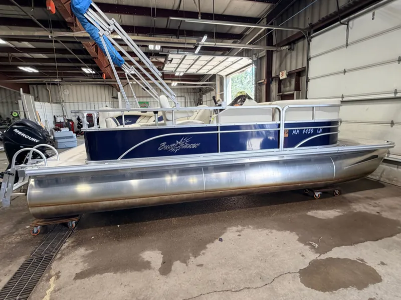 Slide: The Image of A 2015 SunChaser 8520 Classic Cruise pontoon boat is in a warehouse. It features a 30HP Mercury 4Stroke EFI engine. - 49