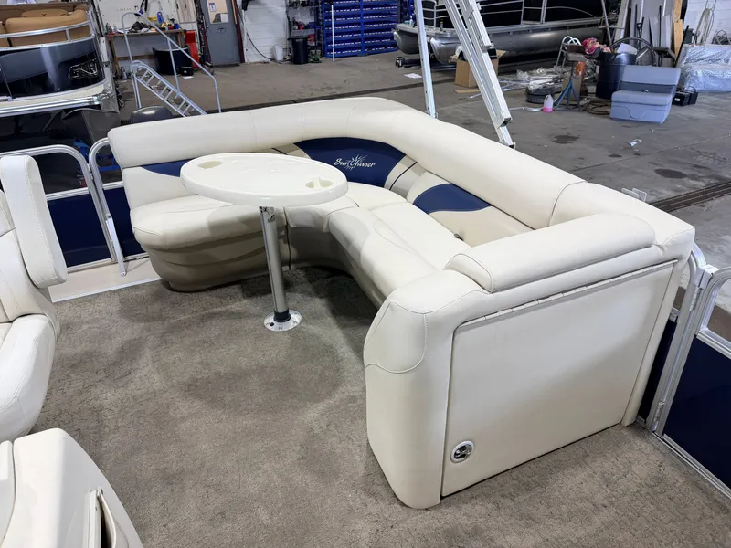 Slide: The Image of The image shows the interior of a SunChaser 8520 Classic Cruise boat with beige seating and a table. - 26