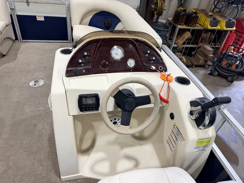 Slide: The Image of The image shows the helm of a 2015 SunChaser 8520 Classic Cruise boat. - 19