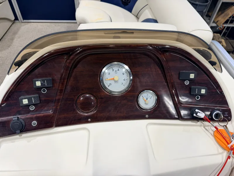 Slide: The Image of The image shows the dashboard of a SunChaser 8520 Classic Cruise boat with wood accents and instruments. - 20