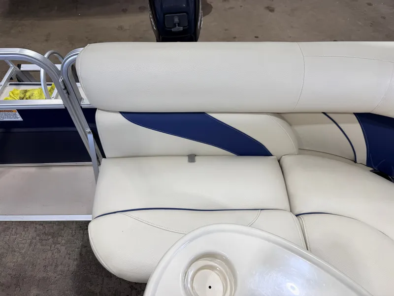 Slide: The Image of The image shows a white and blue seating area on a boat with a cup holder. - 30