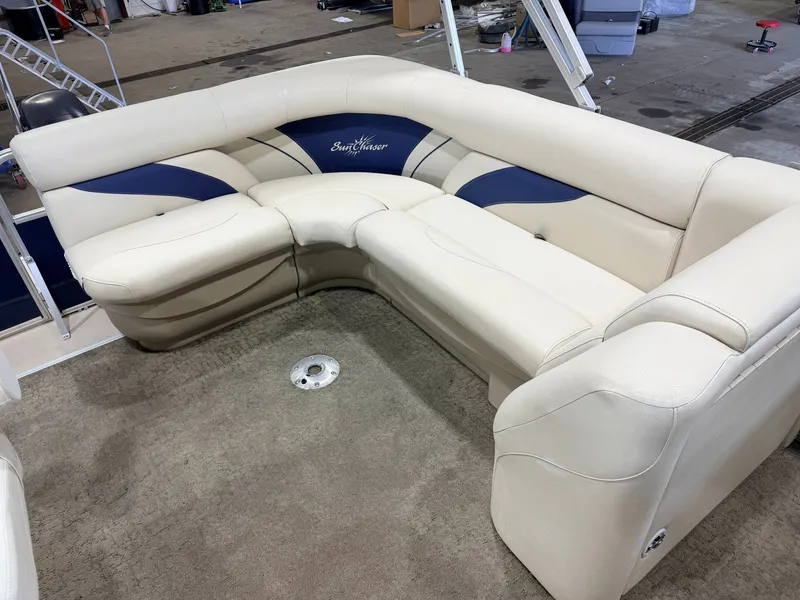 Slide: The Image of The image shows a cream-colored L-shaped seating area on a boat. - 32