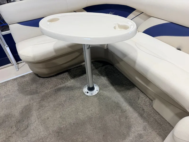 Slide: The Image of A cozy seating area with a round table and cushioned seats on a boat. - 31