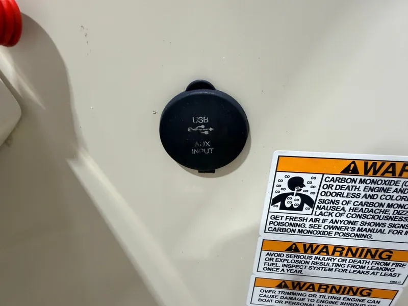 Slide: The Image of USB and AUX input with warning labels on a boat console. - 22