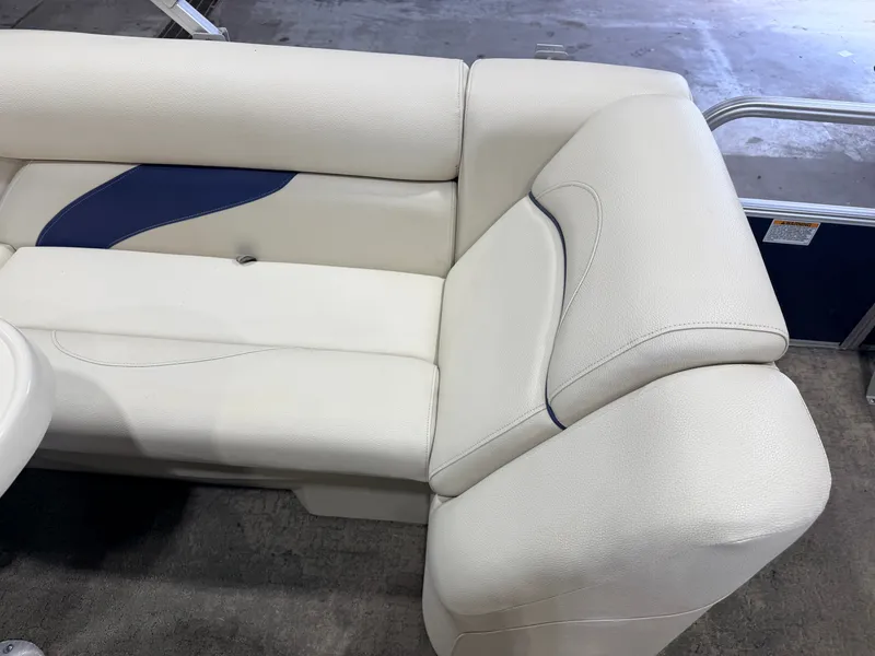 Slide: The Image of The image shows a white upholstered bench seat with blue accents on a boat. - 28