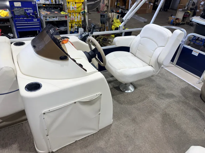Slide: The Image of The image shows the cockpit of a 2015 SunChaser 8520 Classic Cruise boat with a comfortable captain's chair. - 16