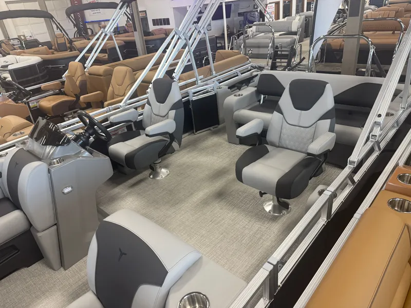 Slide: The Image of Interior of a modern pontoon boat with gray and black seats, steering wheel, and armrests. - 3
