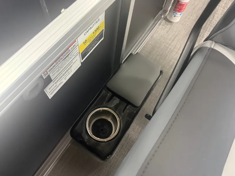 Slide: The Image of A gray seat with a built-in cup holder and safety information on the side. - 16
