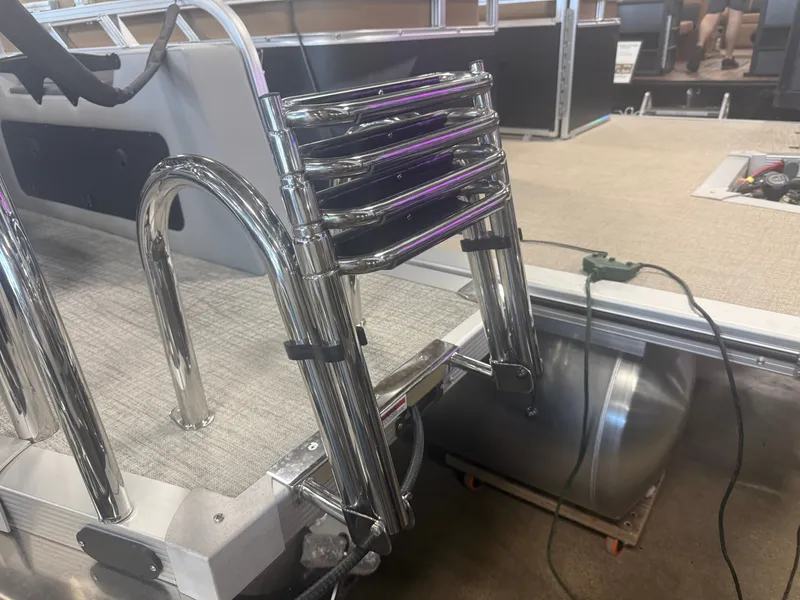 Slide: The Image of A shiny metal ladder is attached to a boat, which is on a trailer. - 34