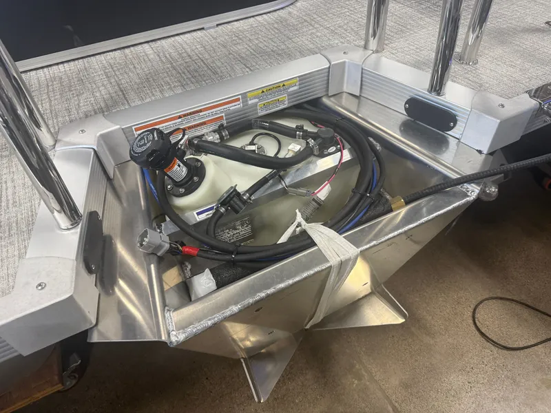 Slide: The Image of An open engine compartment with a fuel tank and hoses in a boat. - 33
