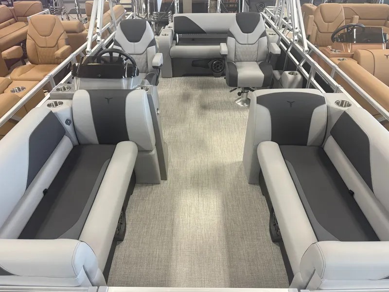 Slide: The Image of Interior of a modern pontoon boat with gray and black seating, steering wheel, and carpeted floor. - 7