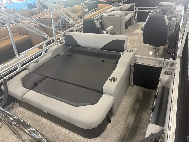 Slide: The Image of Interior of a modern pontoon boat with gray and black seating, steering wheel, and cup holders. - 23