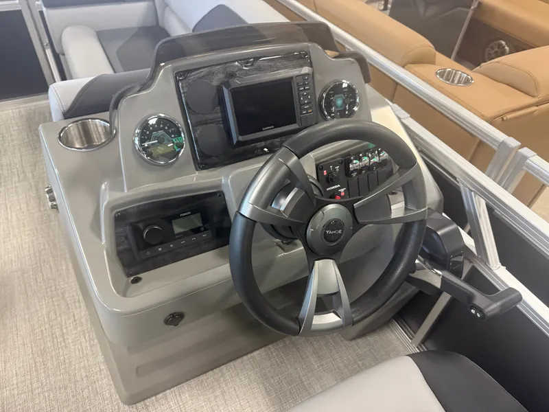 Slide: The Image of The image shows a boat's helm with a modern steering wheel and instruments. - 13