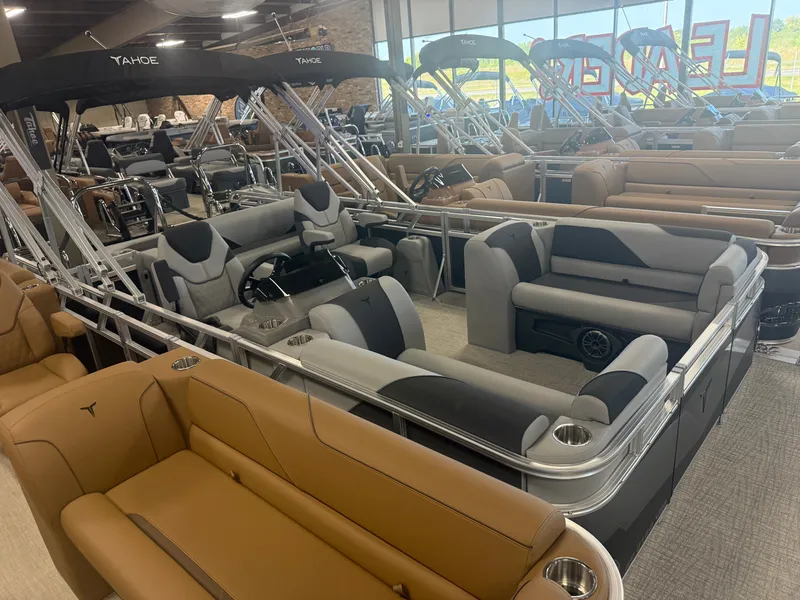 Slide: The Image of Interior view of a showroom with several luxury pontoon boats, including the Tahoe Sport VRB 2180. - 37