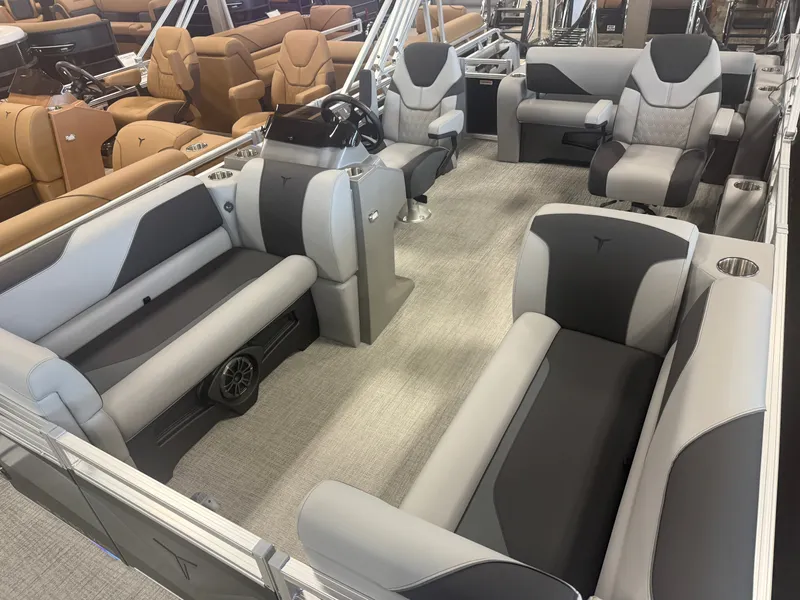Slide: The Image of Interior of a modern pontoon boat with gray and black upholstery, steering wheel, and seating areas. - 30