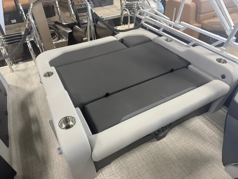 Slide: The Image of The image shows a gray lounging area on a boat with cup holders. - 19