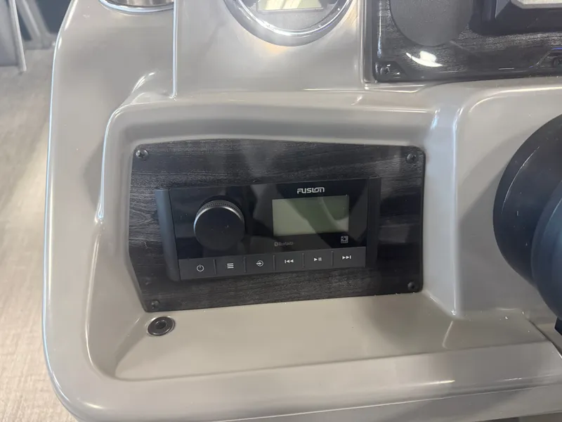 Slide: The Image of Close-up of a boat console area featuring a Fusion audio system. - 14