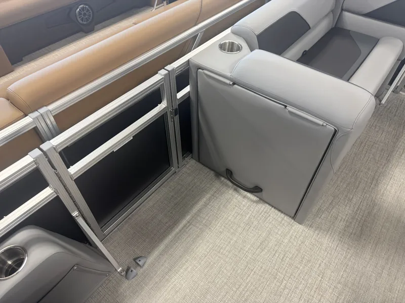 Slide: The Image of The image shows a gray seat on a boat with metal railing and cup holders. - 26