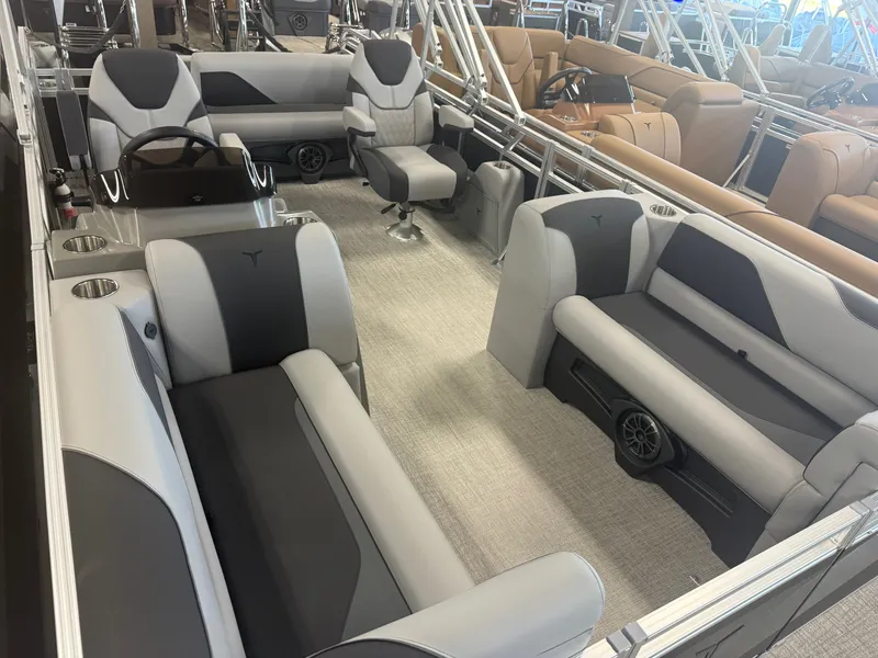 Slide: The Image of Interior of a modern pontoon boat with gray and black seating, steering wheel, and carpeted floor. - 31