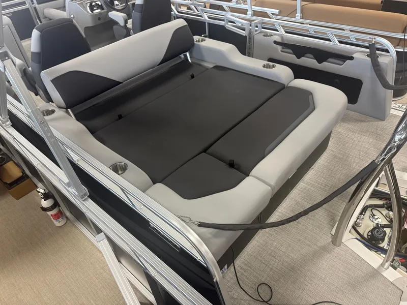 Slide: The Image of The image shows the interior of a modern pontoon boat with a large, cushioned lounging area. - 5