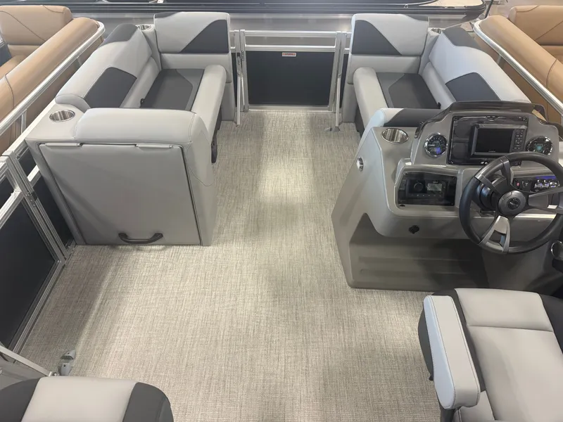 Slide: The Image of Interior of a modern pontoon boat with gray and black seating, steering wheel, and dashboard. - 28