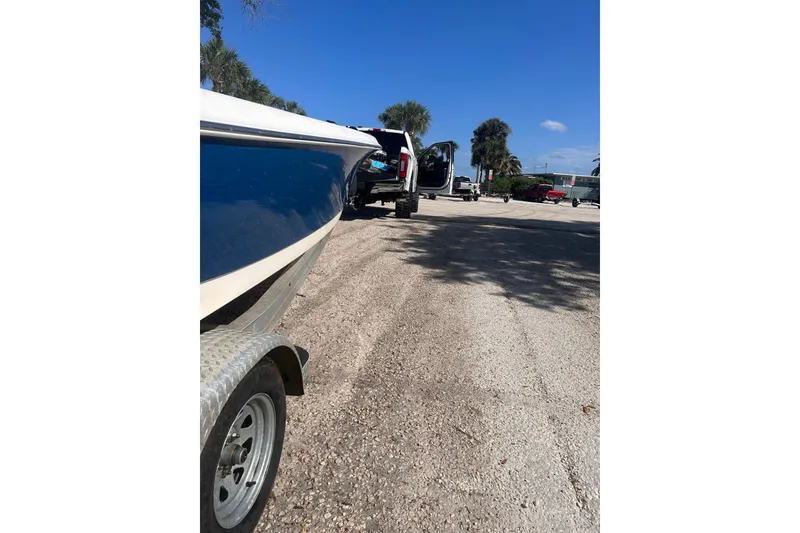 Slide: The Image of 2014 Blue Wave 2300 PureBay boat on trailer in sunny parking lot. - 7