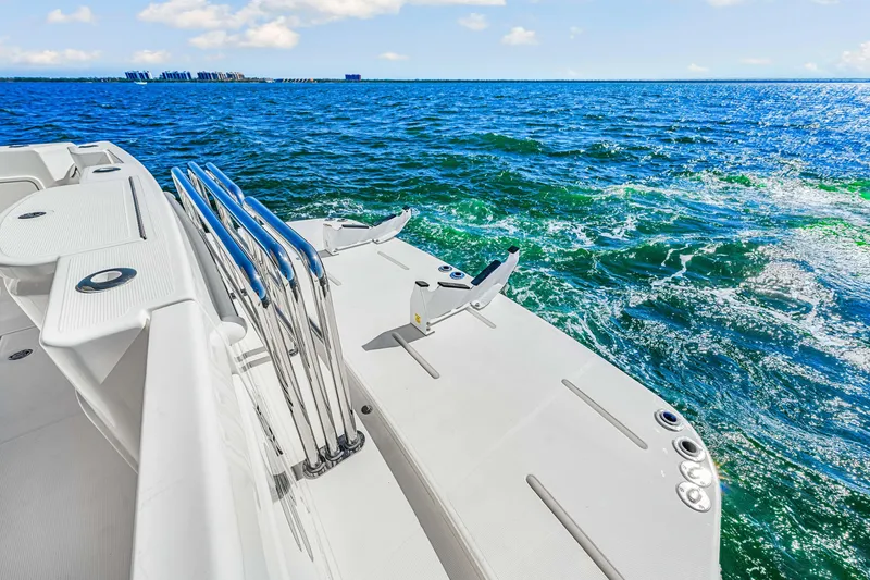 Slide: The Image of 2022 Riviera 505 SUV yacht deck overlooking vibrant blue ocean waters. - 48