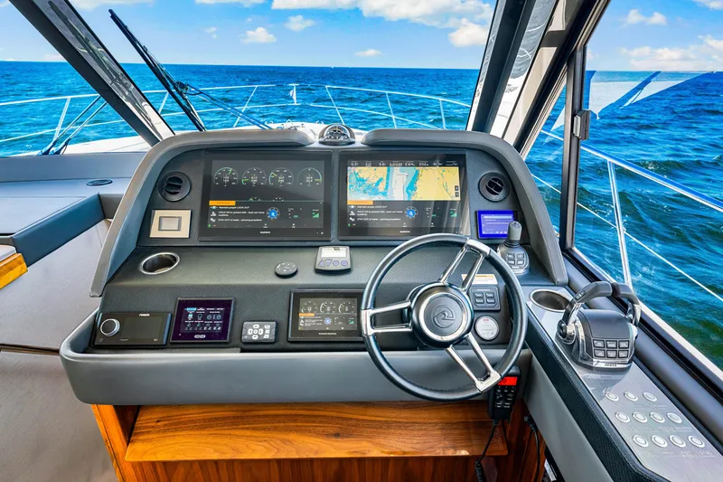 Slide: The Image of 2022 Riviera 505 SUV dashboard with navigation screens and steering wheel, overlooking the ocean. - 25