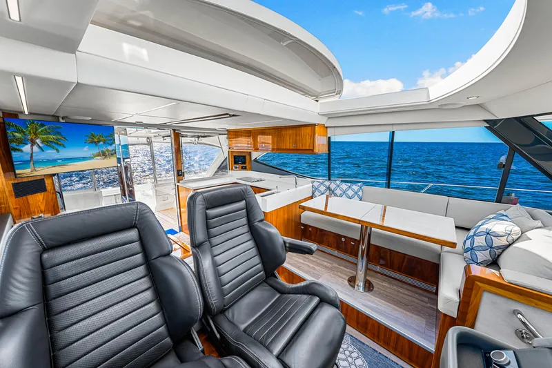 Slide: The Image of Luxurious 2022 Riviera 505 SUV yacht interior with ocean view, featuring leather seating and modern amenities. - 24
