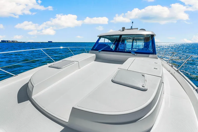 Slide: The Image of 2022 Riviera 505 SUV yacht cruising on open sea under blue sky. - 42