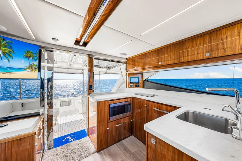 Slide: The Image of Interior of 2022 Riviera 505 SUV yacht with ocean view and modern kitchen design. - 35