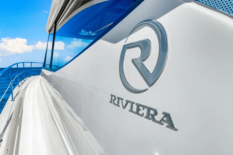 Slide: The Image of 2022 Riviera 505 SUV yacht with logo, cruising on a sunny day. - 49