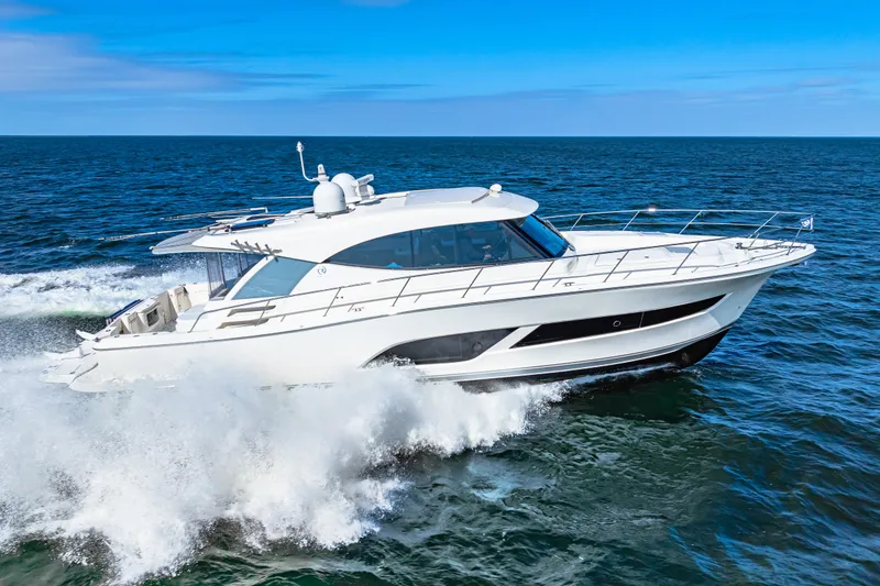 The Image of 2022 Riviera 505 SUV cruising on open sea under clear blue sky. - 1