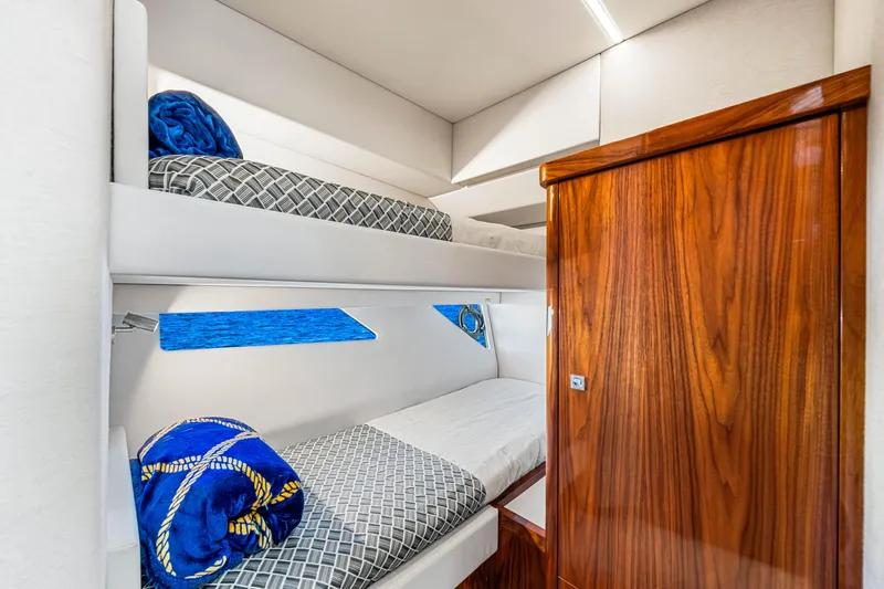 Slide: The Image of 2022 Riviera 505 SUV interior with wooden accents and bunk beds. - 11