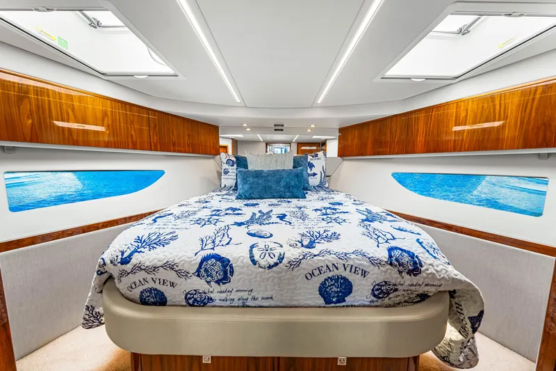 Slide: The Image of Luxurious bedroom interior of 2022 Riviera 505 SUV yacht with ocean-themed bedding. - 12