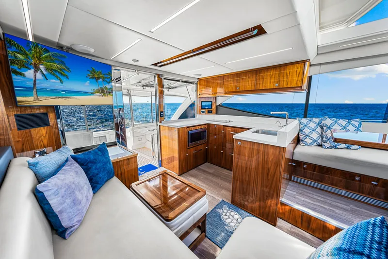 Slide: The Image of Luxurious interior of 2022 Riviera 505 SUV yacht with ocean view and elegant wood finishes. - 33