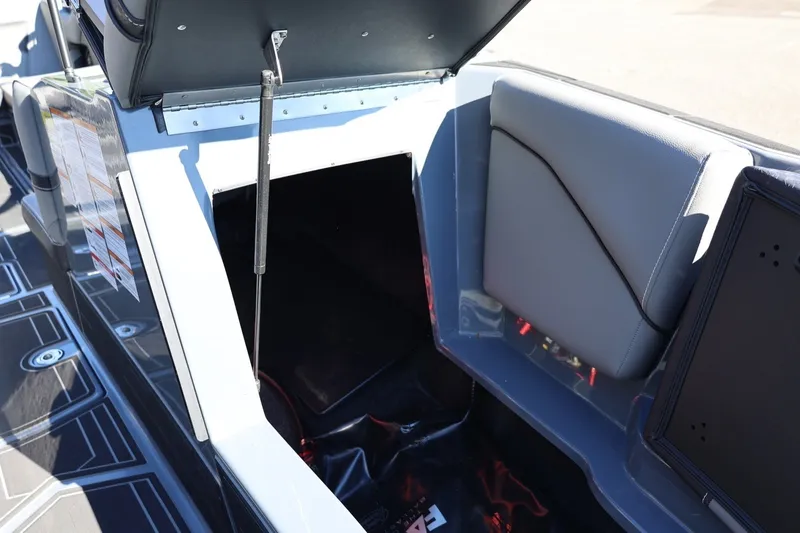 Slide: The Image of Open storage compartment in 2022 Supreme ZS252 boat with cushioned seating. - 61